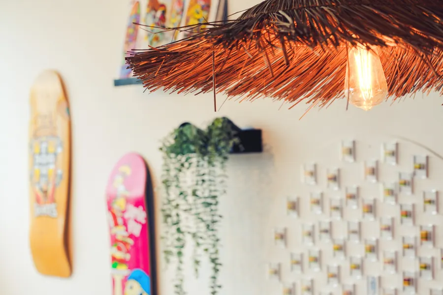 Skateboard decks and a woven lampshade inside the restaurant