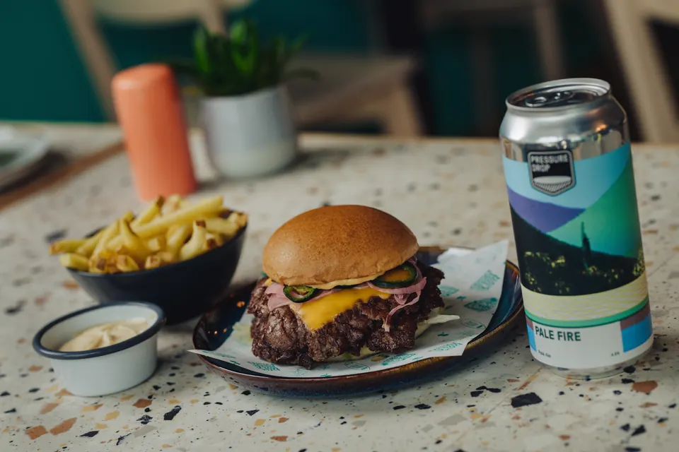 Double cheeseburger, fries and a can of Pale Fire pale ale