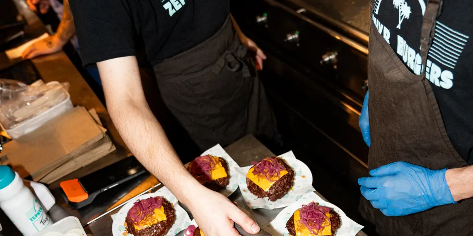 The Zephyr team building burgers on the pass